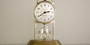 a clock with a gold base