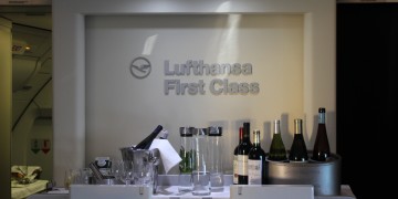 a group of wine glasses and bottles on a white surface