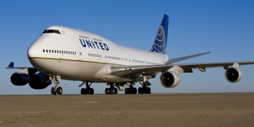 a large white airplane on a runway