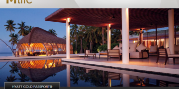 a pool with a gazebo and chairs