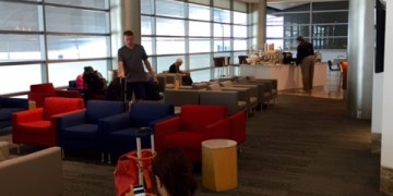 a man and woman sitting in chairs in a lounge area