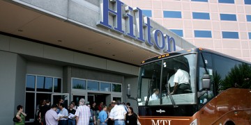 a group of people outside a hotel