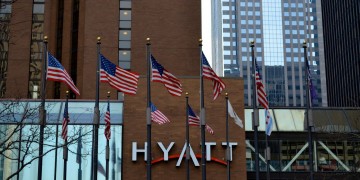 a group of flags in front of a building