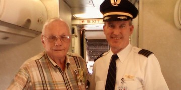 two men standing in a plane