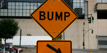 a street sign with a sign pointing to the left