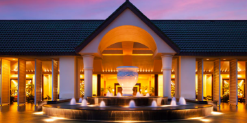 a building with a fountain and a pool