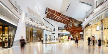 a large shopping mall with people walking around