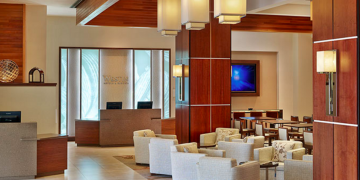 a lobby with a reception desk and chairs