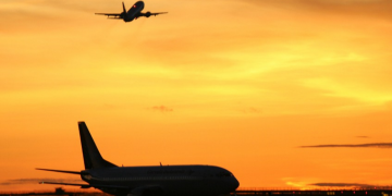 an airplane flying over an airport