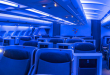 an airplane interior with blue seats