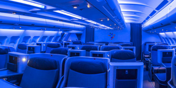 an airplane interior with blue seats