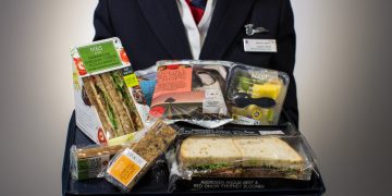 a person holding a tray of food