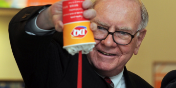 a man holding a container of food