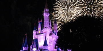 a castle with fireworks in the background