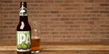 a bottle and glass of beer on a table