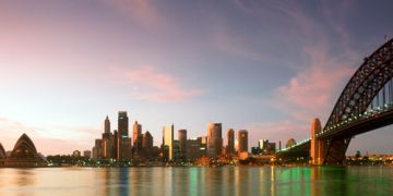 a city skyline with a body of water