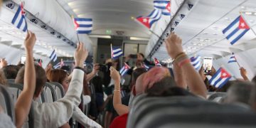 a group of people on an airplane with flags