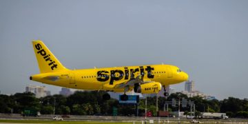 a yellow airplane taking off