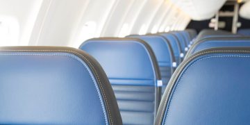 a row of blue seats in an airplane