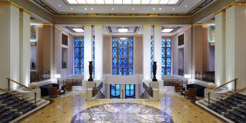 a large hall with marble floor and columns