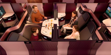 a family sitting at a table in a plane