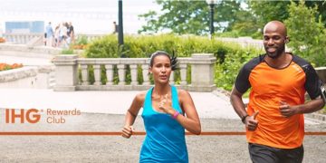 a woman running with a man in the background