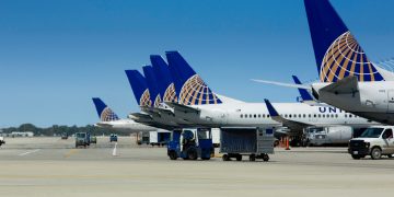 a group of airplanes parked on a runway