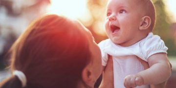 a woman holding a baby