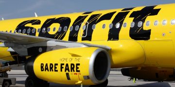 a yellow airplane with black writing on it