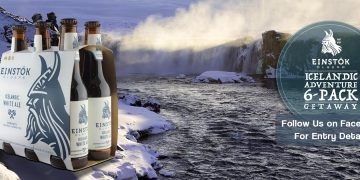 a bottle of beer next to a river