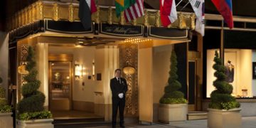 a man standing in front of a hotel entrance