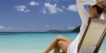 a woman sitting on a beach chair