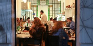 a group of people sitting at tables