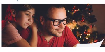 a man and a girl looking at a tablet