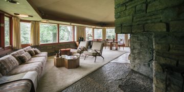 a living room with a stone fireplace and a couch