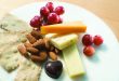 a plate of food with grapes and cheese