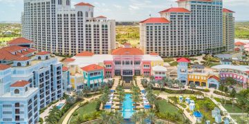 a group of buildings with a pool in front of them