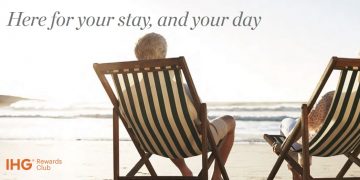 a man sitting in a chair on a beach