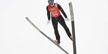 a person in a ski suit jumping in the air