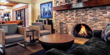 a living room with a fireplace and a couch