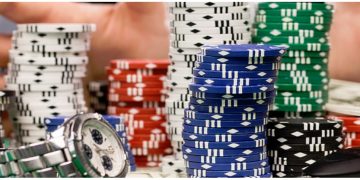 a stack of poker chips and a watch