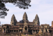 a large building with many towers with Angkor Wat in the background