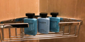 a group of bottles of shampoo on a metal rack