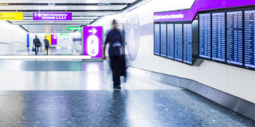 a blurry man walking in a train station