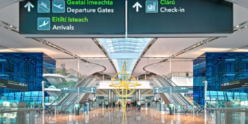 a large airport with escalators and signs