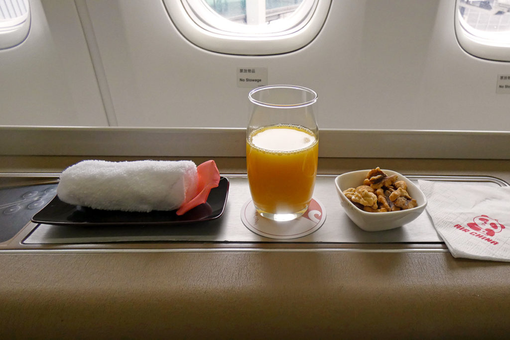 Hot towel, orange juice and nuts