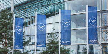 a group of blue flags in front of a building