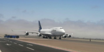 a large white airplane on a runway