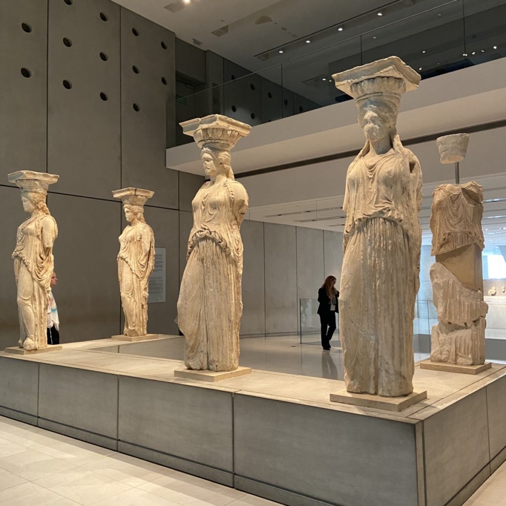 a group of statues in a museum