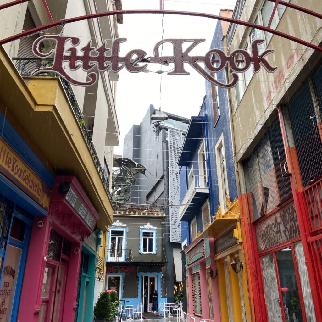 a street with colorful buildings and a sign